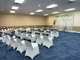 A Room With Rows Of White Chairs